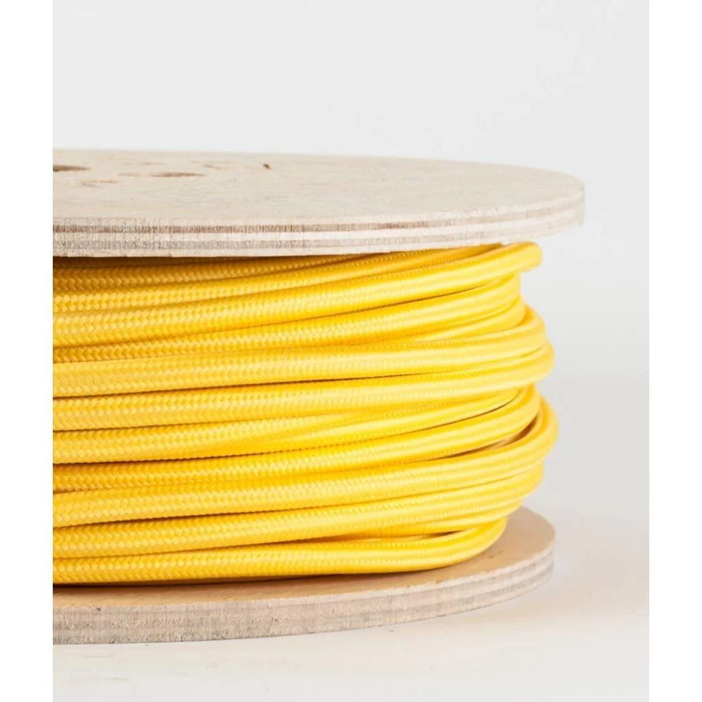 Yellow braided fabric cable rolled on a spool, visible two copper cores within a thin fabric sheath.