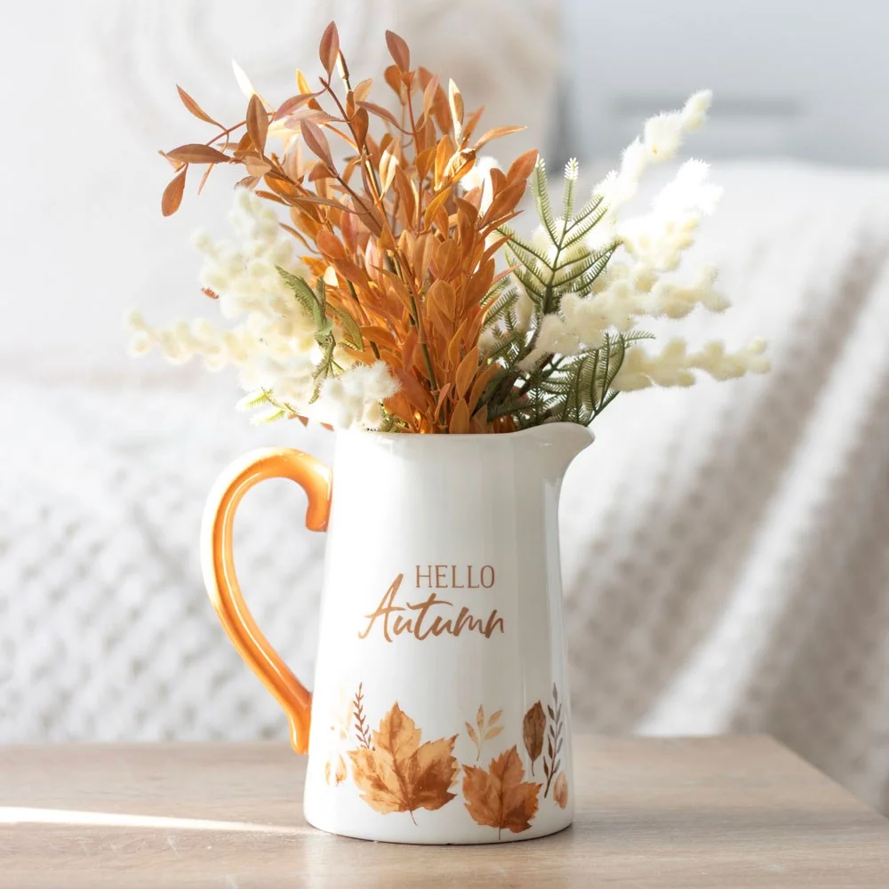 White 17cm ceramic flower jug with painterly leaf design and contrasting handle, ideal for autumnal blooms display