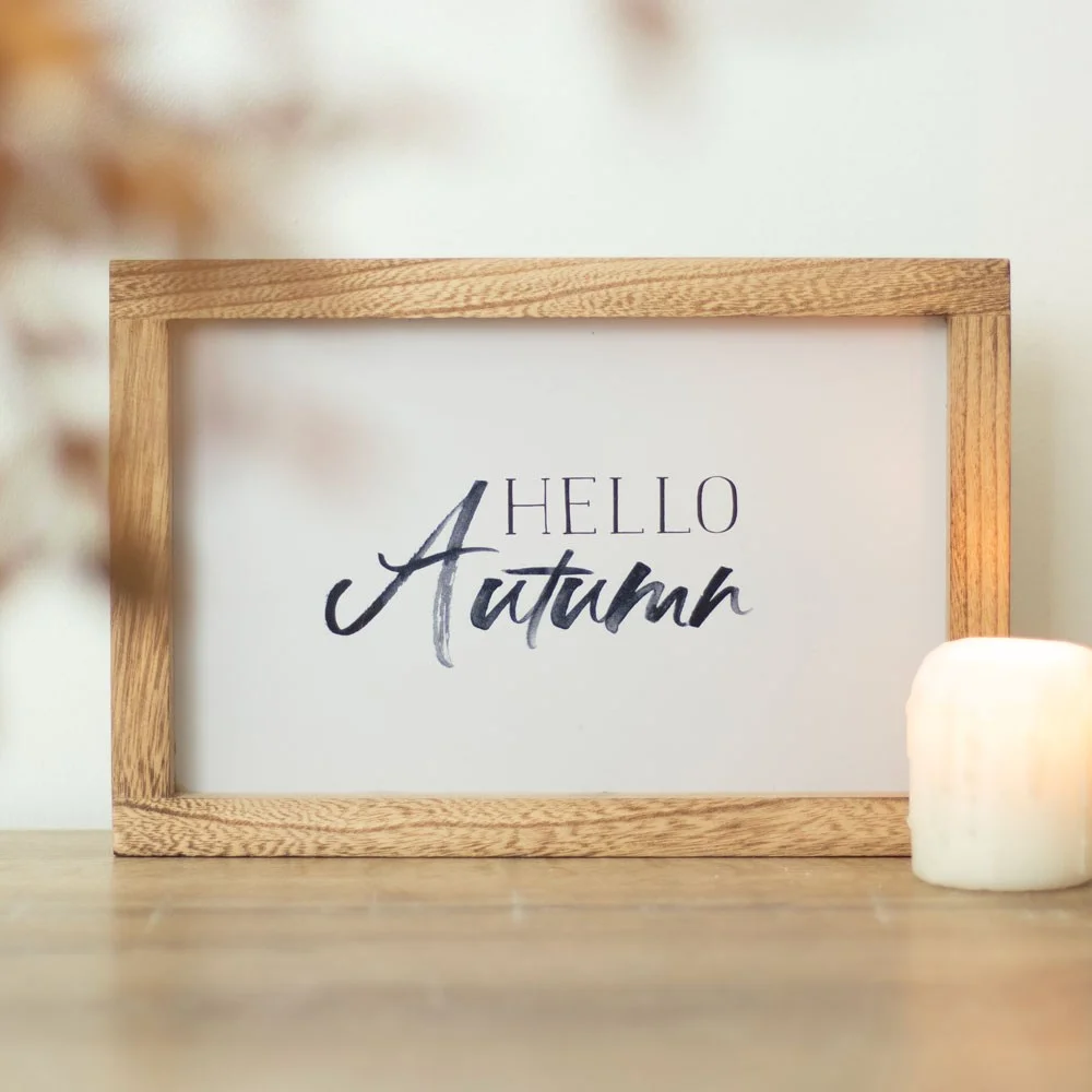 Hello Autumn text in painterly style on cream background, light wood autumn wooden frame sign with sawtooth hanger