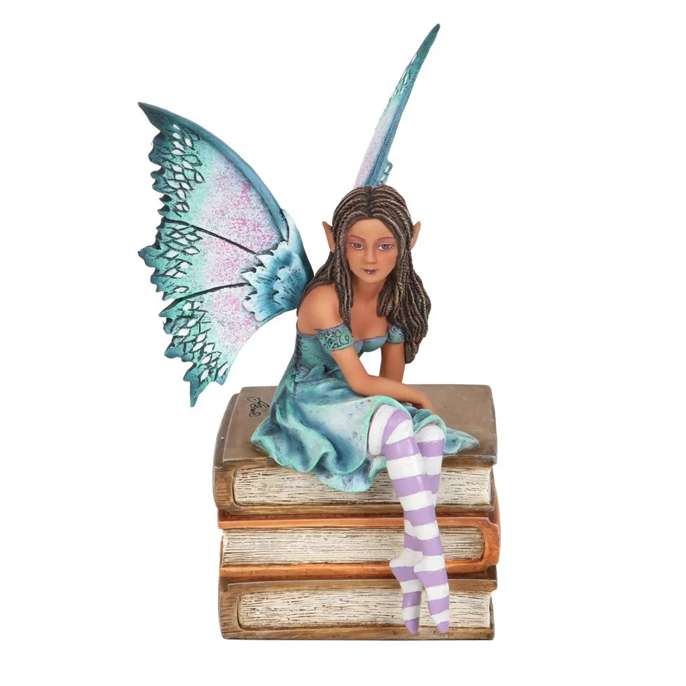 Amy Brown fairy figurine sitting on books, purple and teal colors, detailed resin sculpture from Book Fairy series