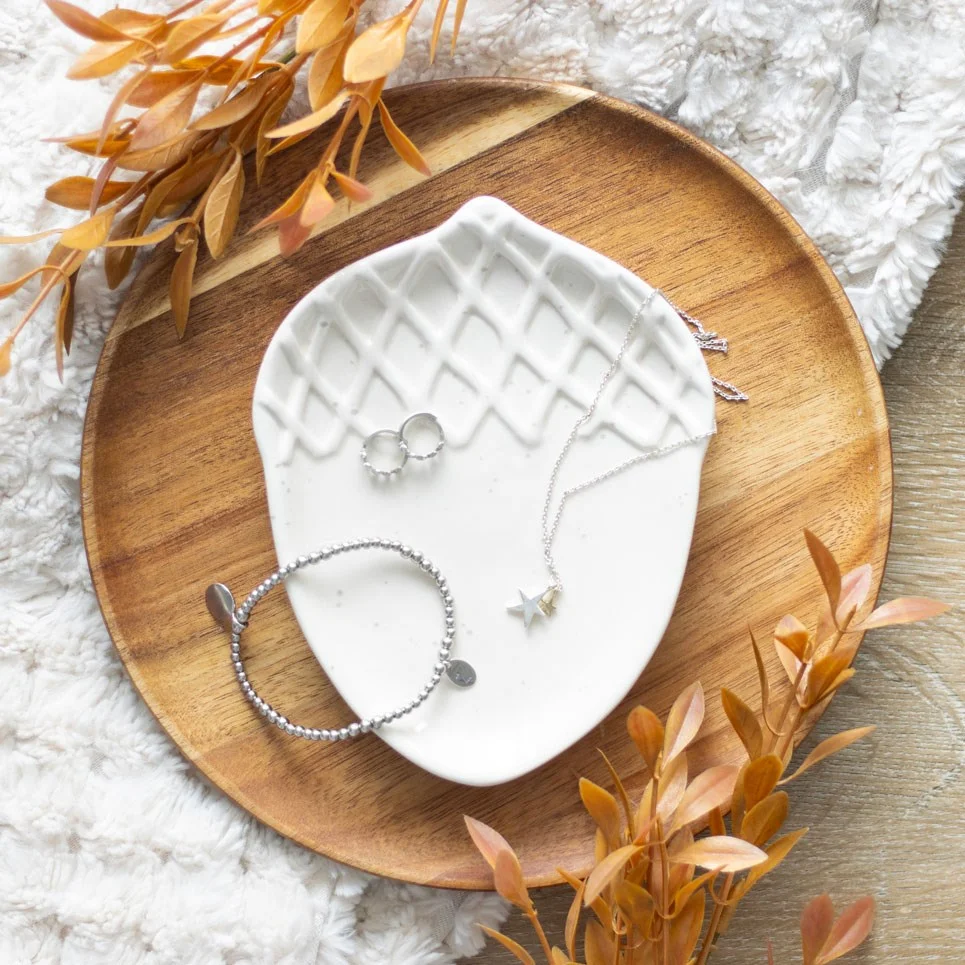 Ceramic autumn acorn dish with detailed acorn shape, perfect for holding trinkets or jewellery on a tabletop