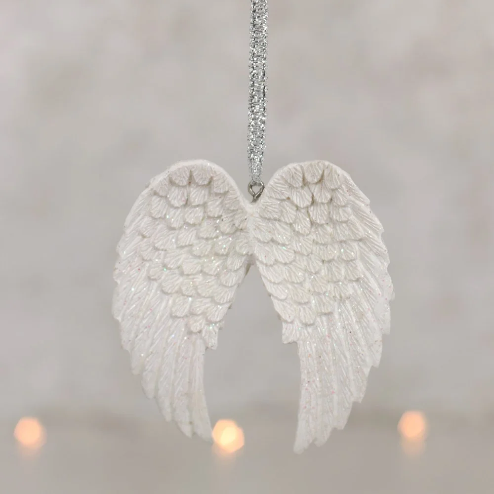 White double angel wing with iridescent glitter on metallic silver ribbon, making a stylish angel wing wall decor