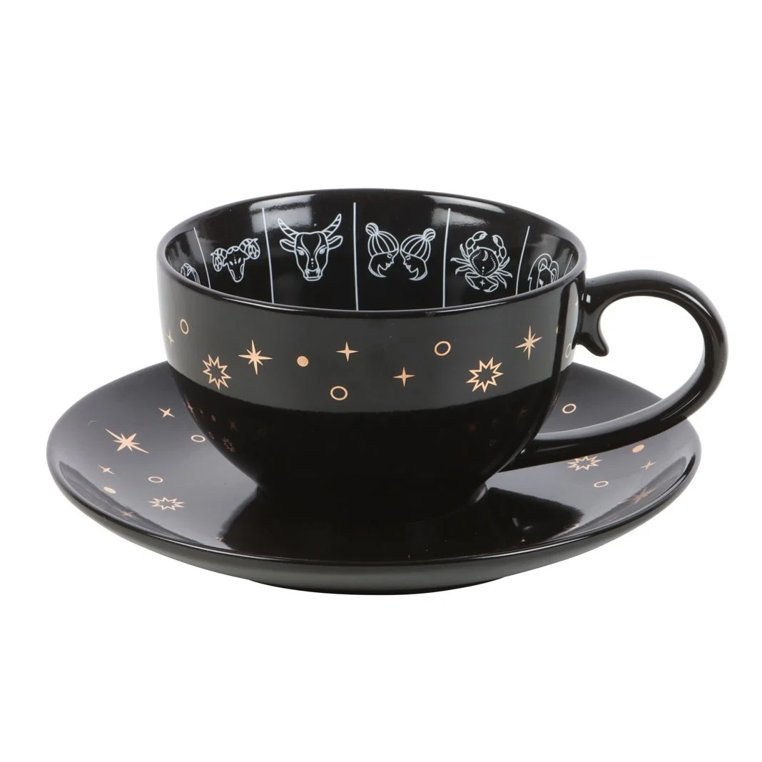 Black astrology teacup with zodiac wheel design in white and gold, on matching black saucer, 500ml capacity