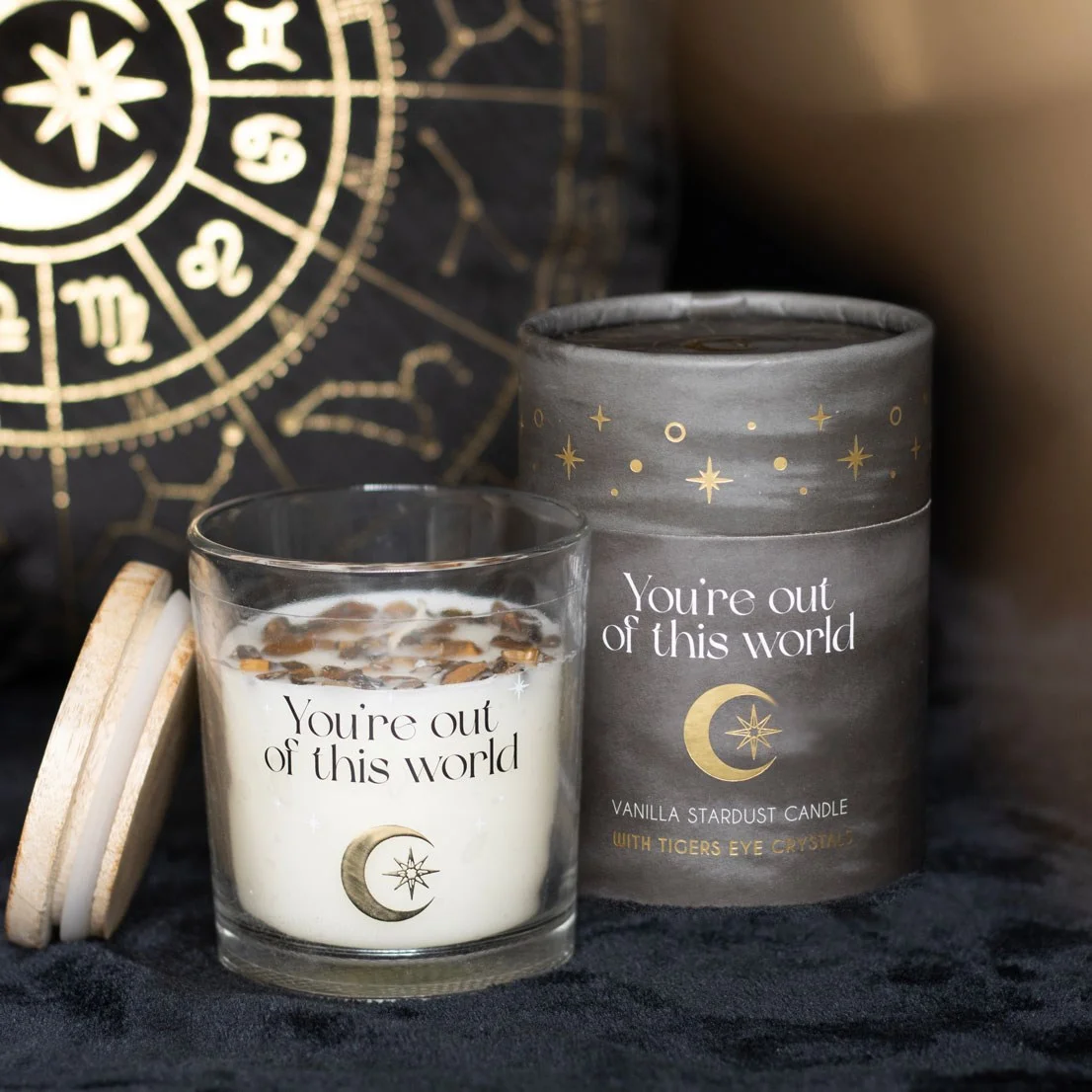 Vanilla scented candle in glass holder with "You're out of this world" text and Tiger's Eye crystal chips on top