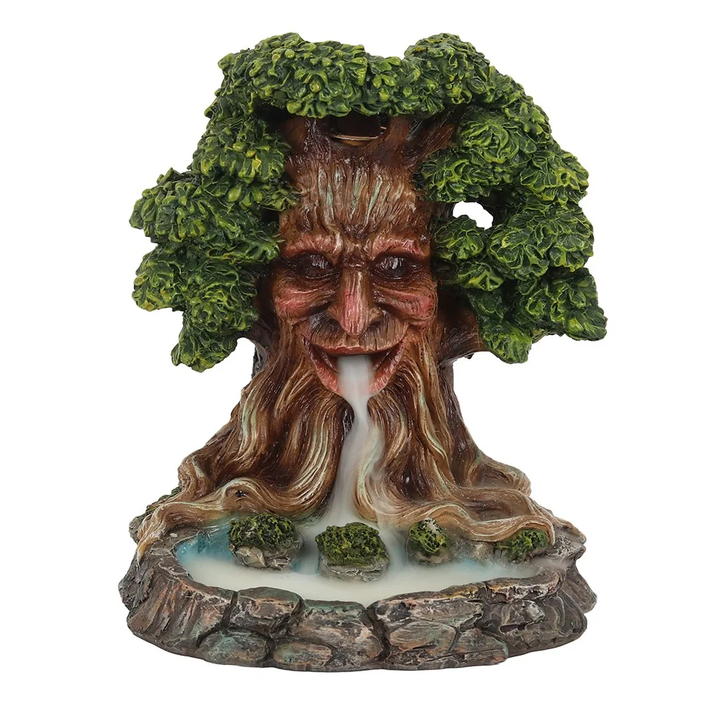 Whimsical Tree Man backflow incense burner with smoke flowing from mouth into blue pond below on leaves holder