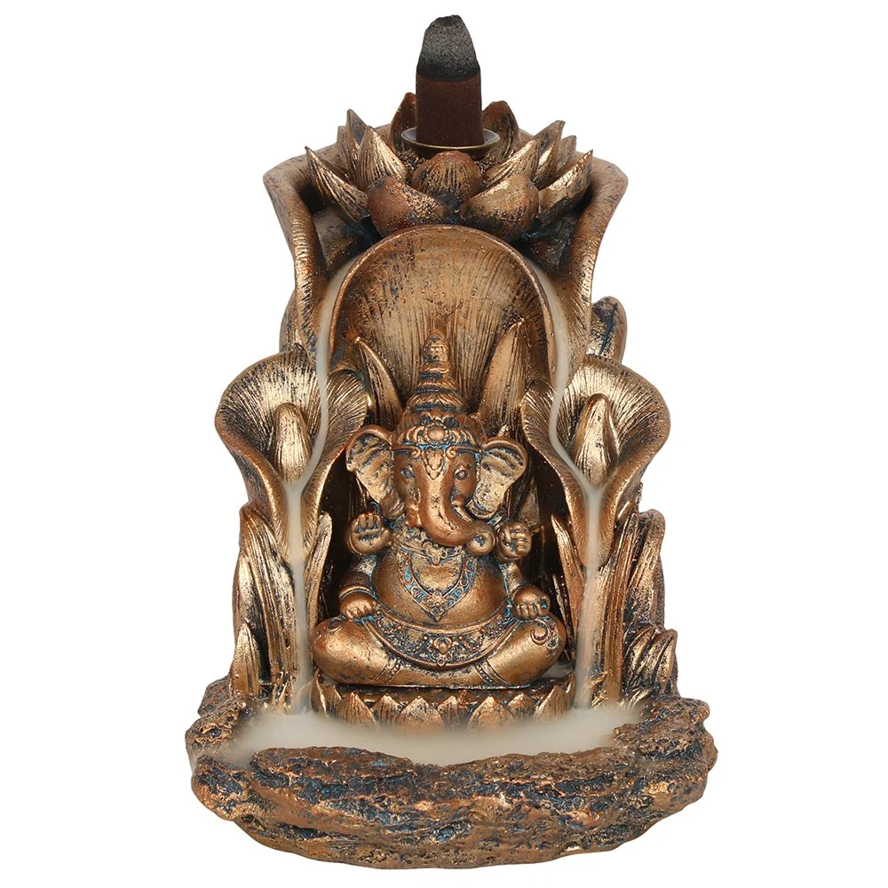 Intricate bronze Ganesh incense burner with lotus leaf design, showing cascading smoke effect from backflow cone burner