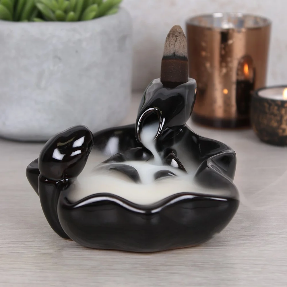 Black ceramic backflow incense burner with pool-to-pool design creating a cascading smoke waterfall effect