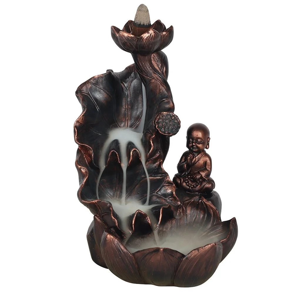 Bronze effect Buddha backflow incense burner with oversized flowers and smoke cascading over the petals below