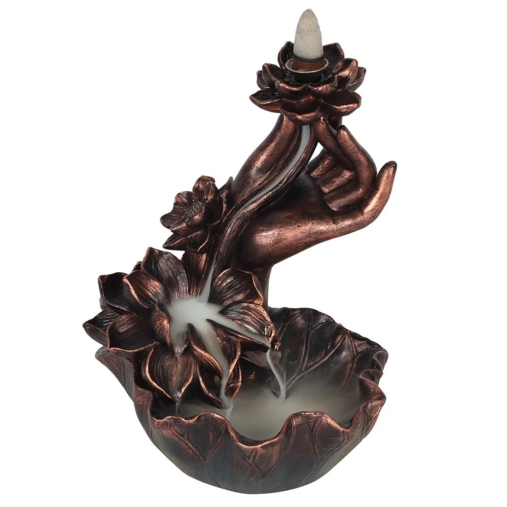 Bronze effect backflow incense burner shaped as a hand holding a lotus flower with smoke cascading down