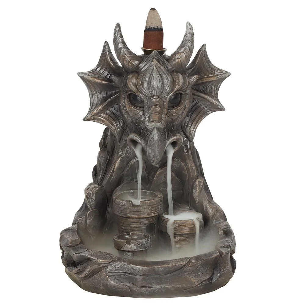 Grey dragon incense burner with horned dragon face and small castle, smoke flows from dragon's nose down rocky cliffs