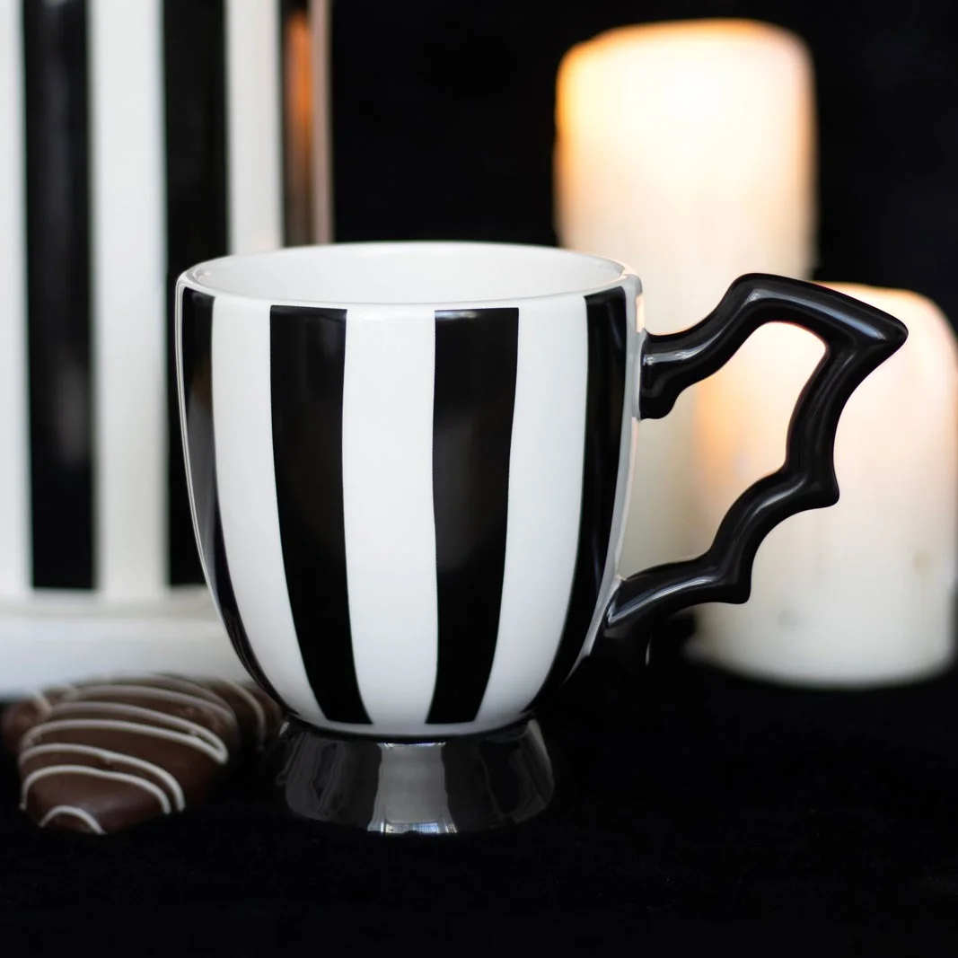 Striped bat wing teacup with bold bat wing handle and monochrome stripes, 490ml capacity, handwash only.
