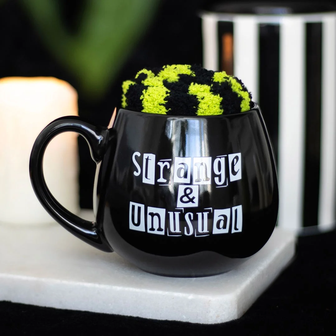 Strange unusual mug set featuring a 500ml mug with "Strange and Unusual" text and matching stripey socks