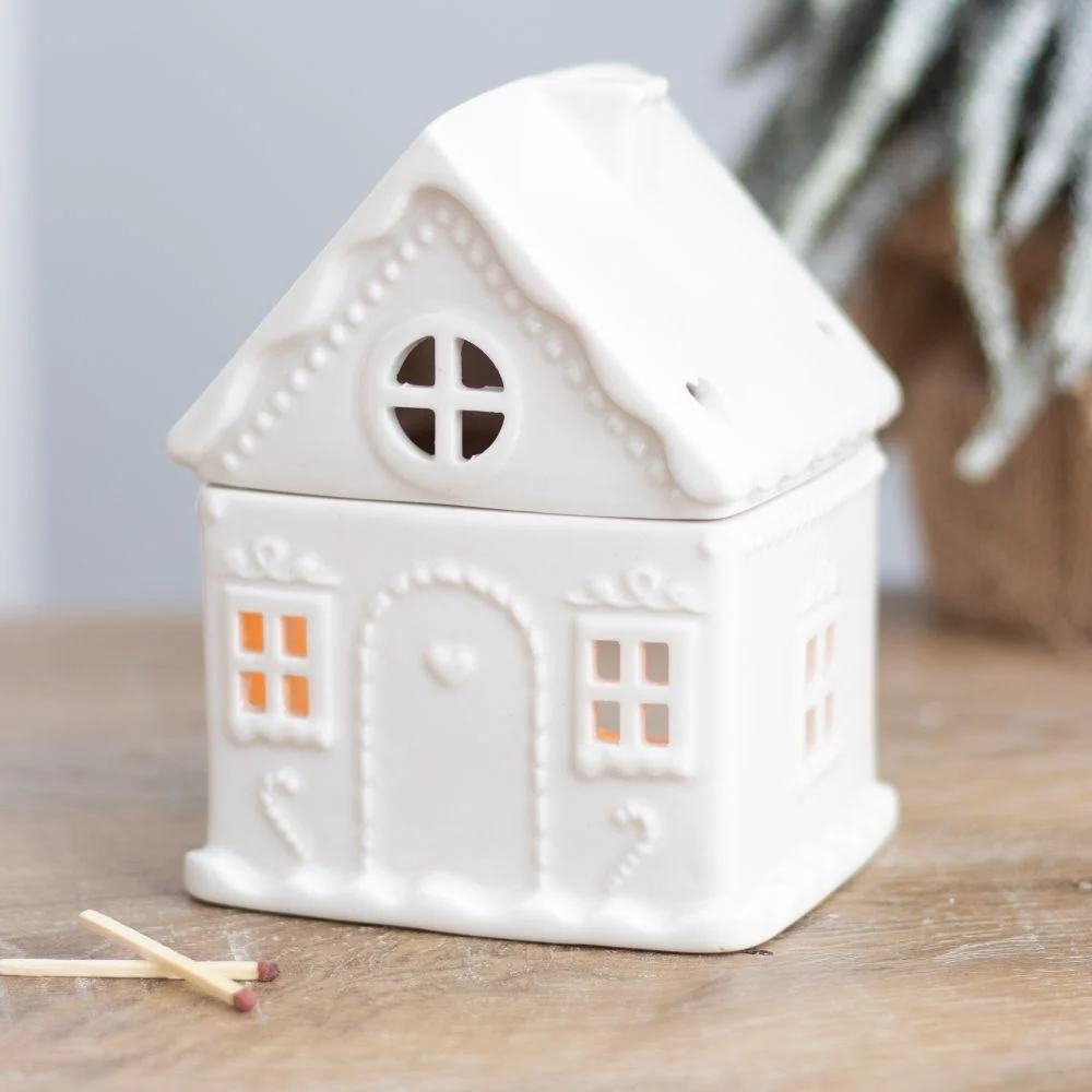 White ceramic gingerbread house oil burner with lid, designed for tealight and fragrance oil use, festive Christmas decor