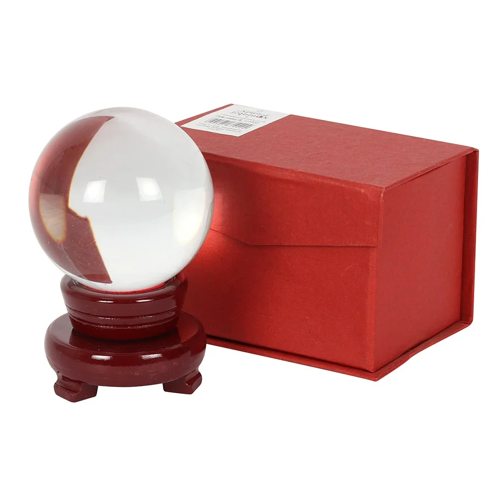 8cm crystal ball resting on a small wooden stand against a plain background