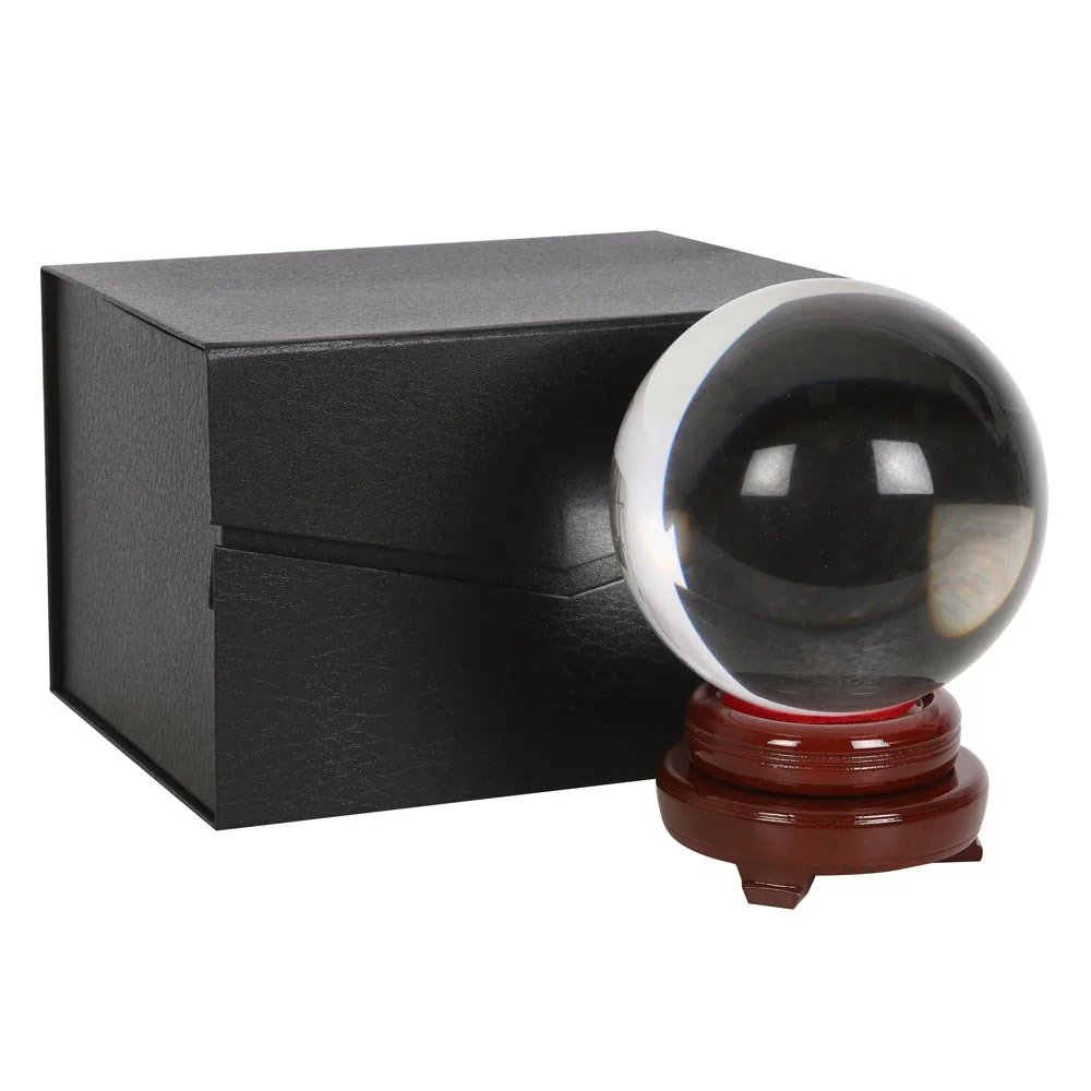 Small 15cm crystal ball with stand, displayed on a wooden stand inside a display box.