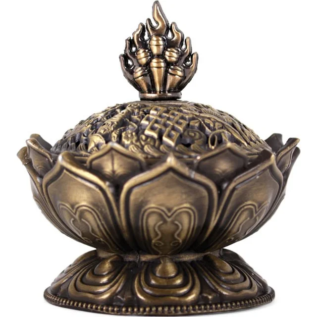 Brass metal incense cone holder shaped like a lotus flower with smoke curling through the top lid