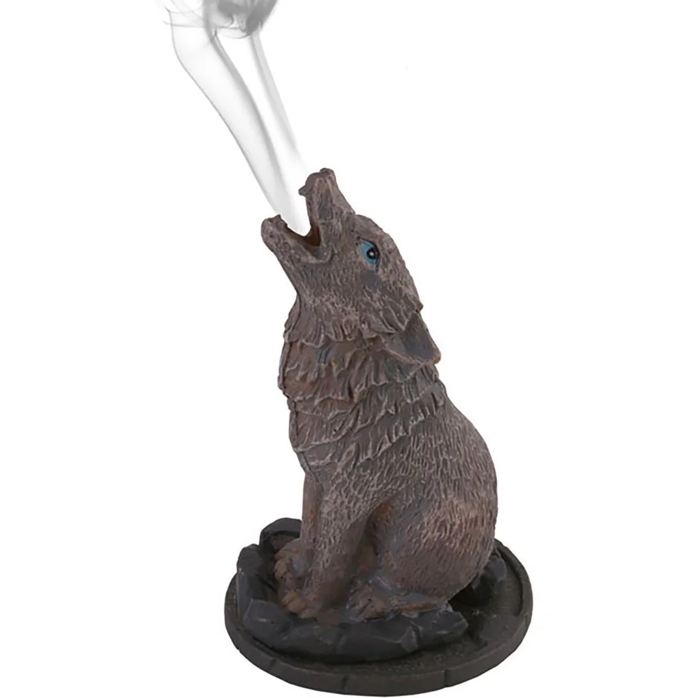 Wolf incense cone holder featuring a howling wolf design, smoke emerging from its mouth as the incense cone burns.