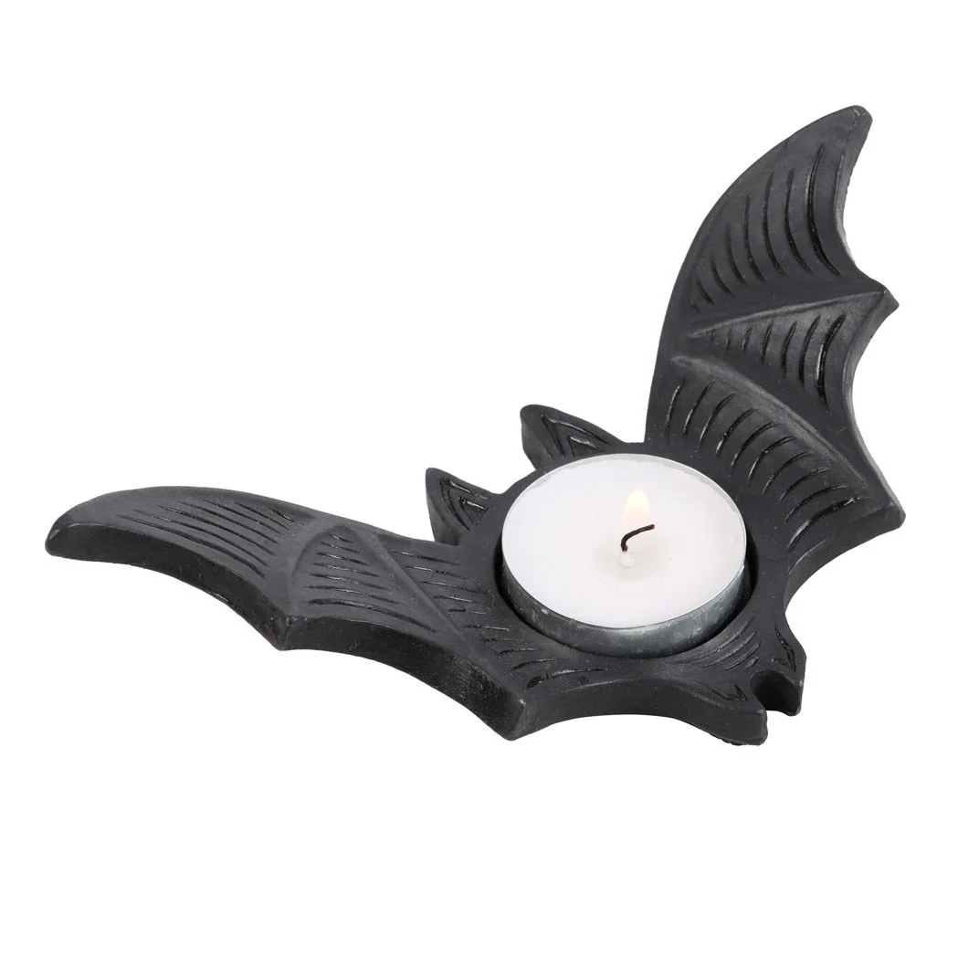 Black resin bat tealight candle holder with detailed wings, holding a single lit tealight candle inside