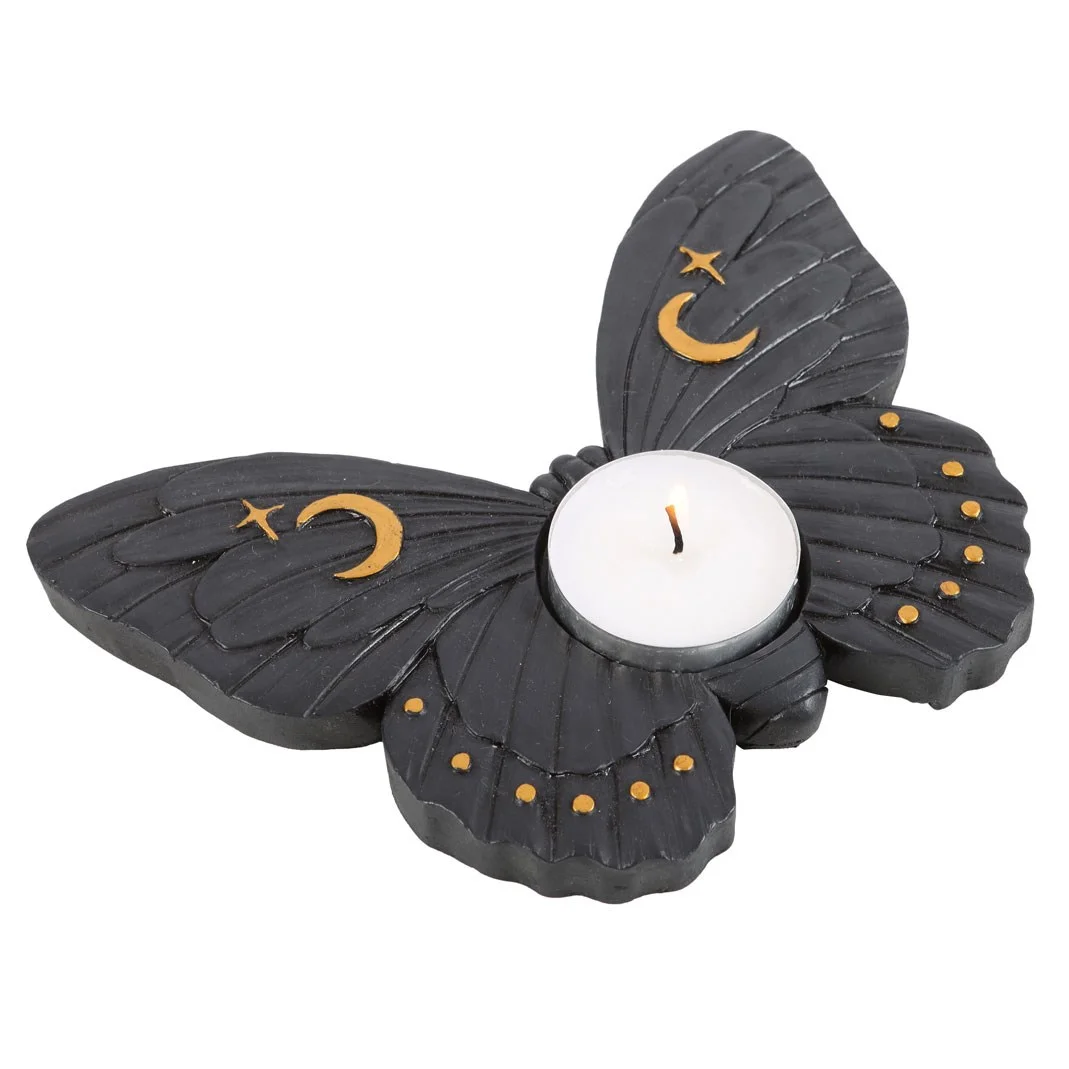Black moth tealight holder with resin moth design, gold crescent moon and stars, holding a lit tealight candle