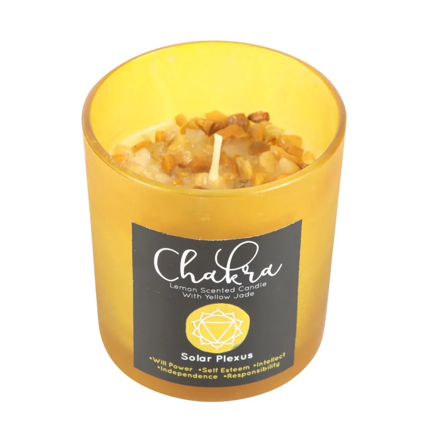 Yellow frosted glass solar plexus chakra candle with lemon scent, metallic lid, and yellow jade crystal chips on top