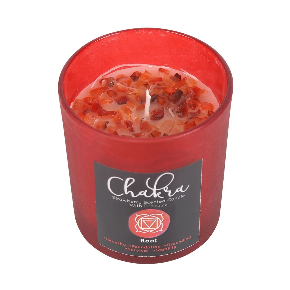 Red frosted glass root chakra candle with metallic lid and fire agate crystal chips on top, strawberry scent