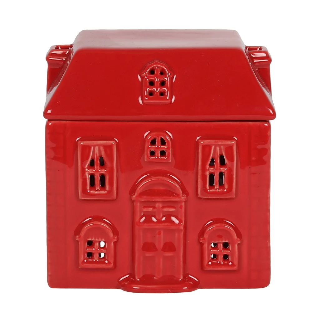 Red ceramic oil burner shaped like a house with a removable lid and bowl for fragrance oil on a white background
