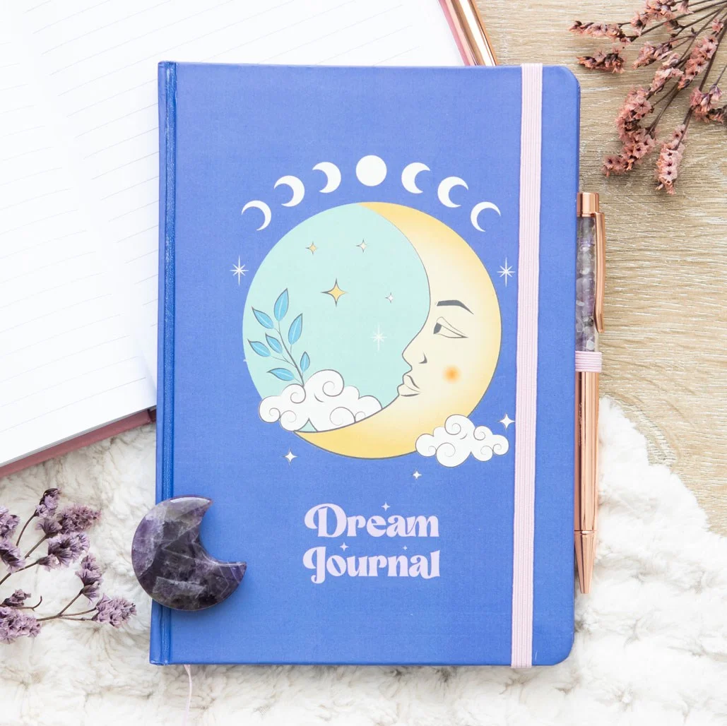 Moon Dream Journal with vibrant moon artwork on cover and included purple amethyst pen on white background