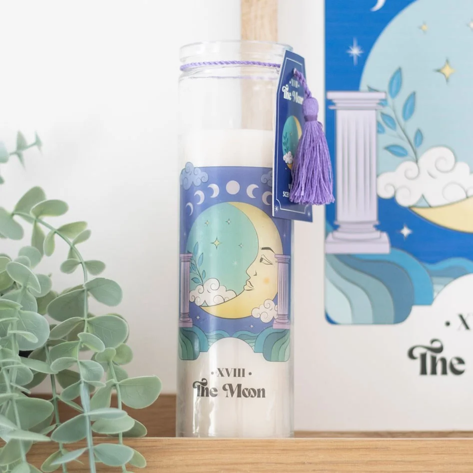 Violet scented candle in a tube with The Moon tarot card design, glowing softly on a white background