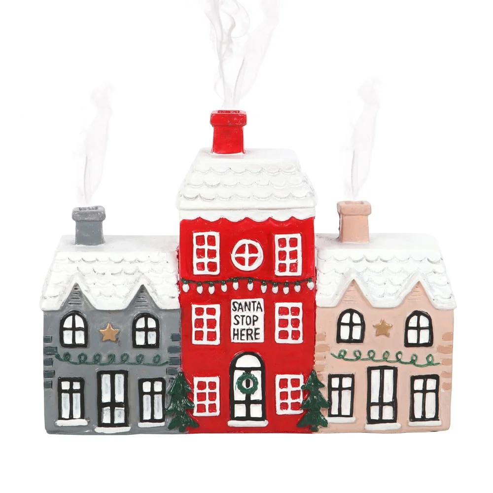 Christmas incense holder shaped as three miniature festive houses with smoke coming from the chimney