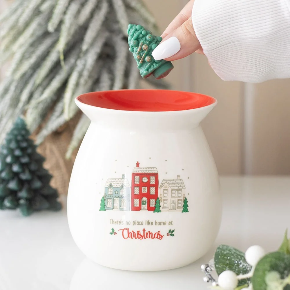 Ceramic wax melt burner with red dish and green Christmas tree wax melt, village scene and festive text on side