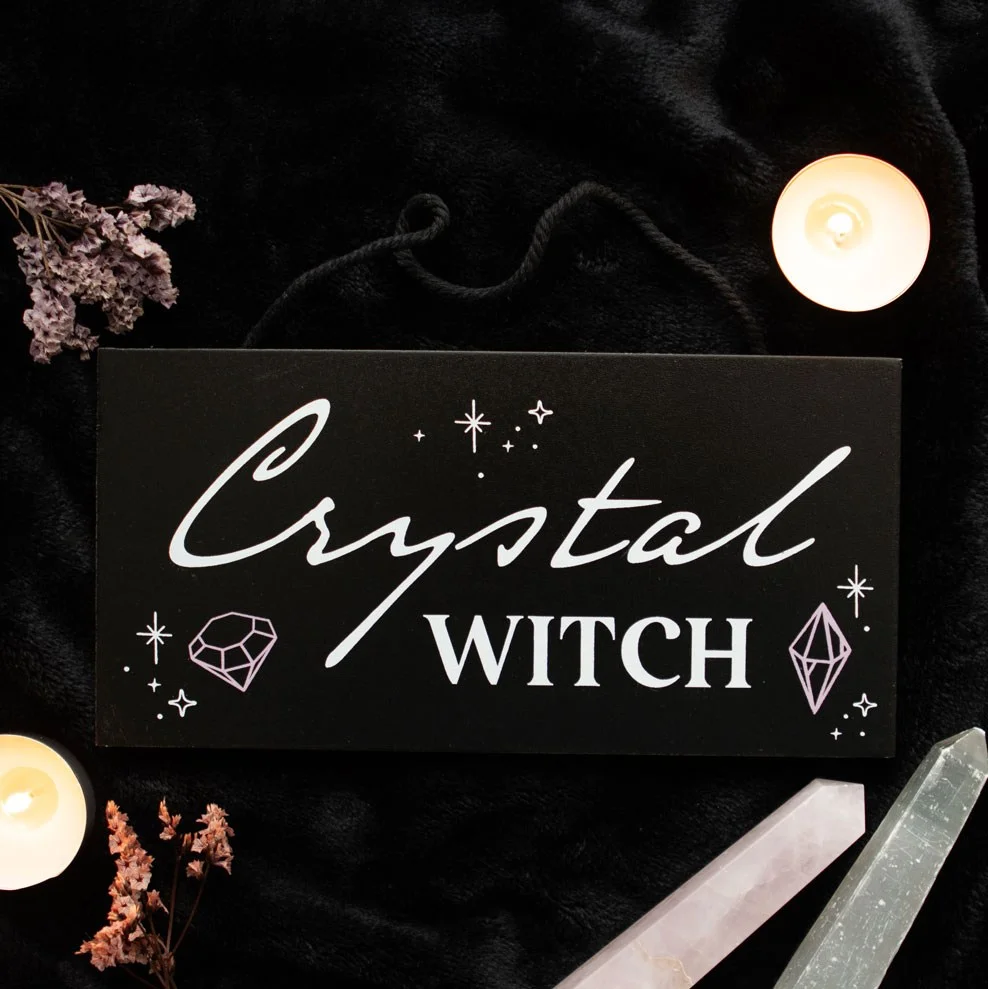 Crystal witch hanging sign with mystical text on a dark background, perfect for magical home decor enthusiasts