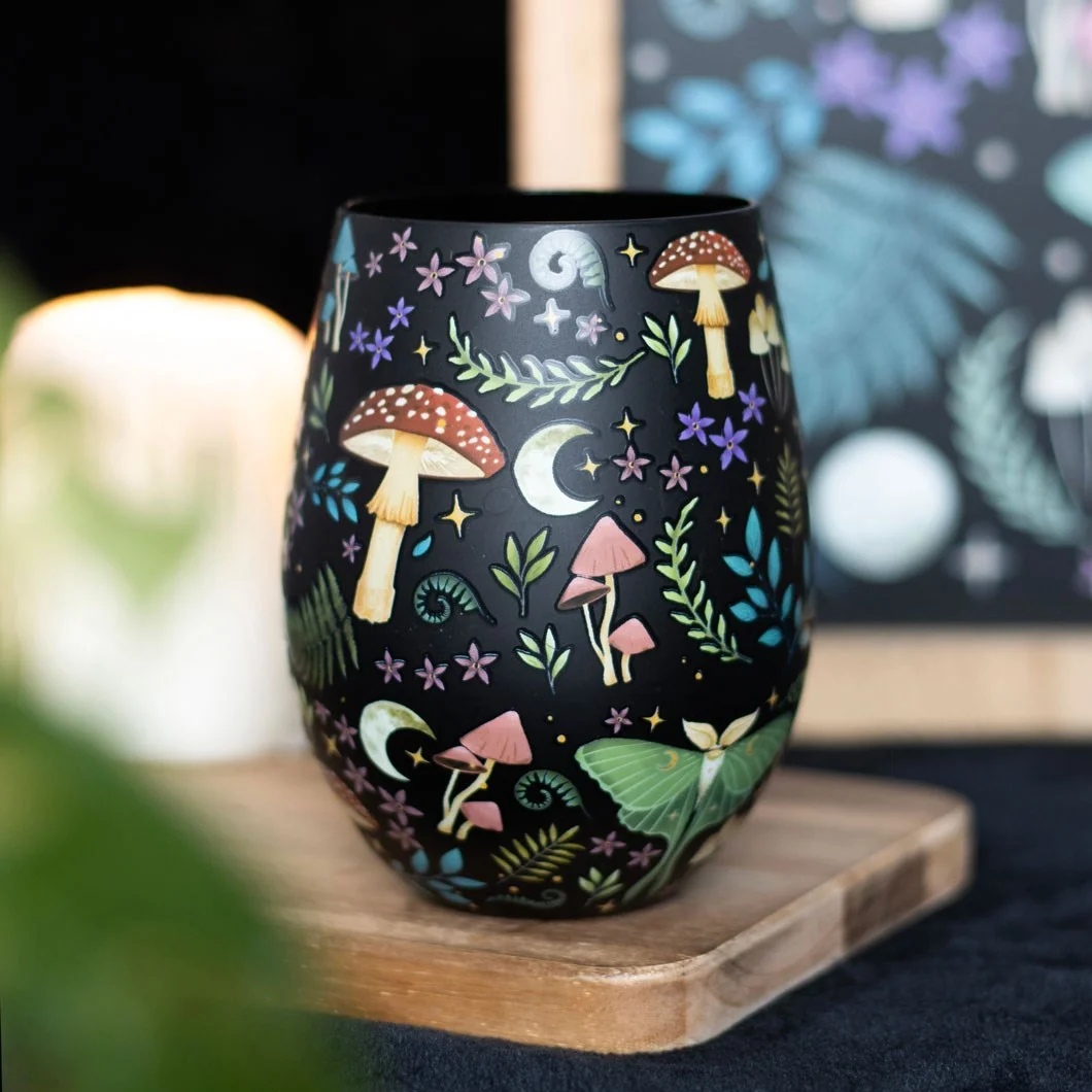 Stemless dark forest glass with night forest design, florals, toadstools, luna moths, moon, and stars pattern