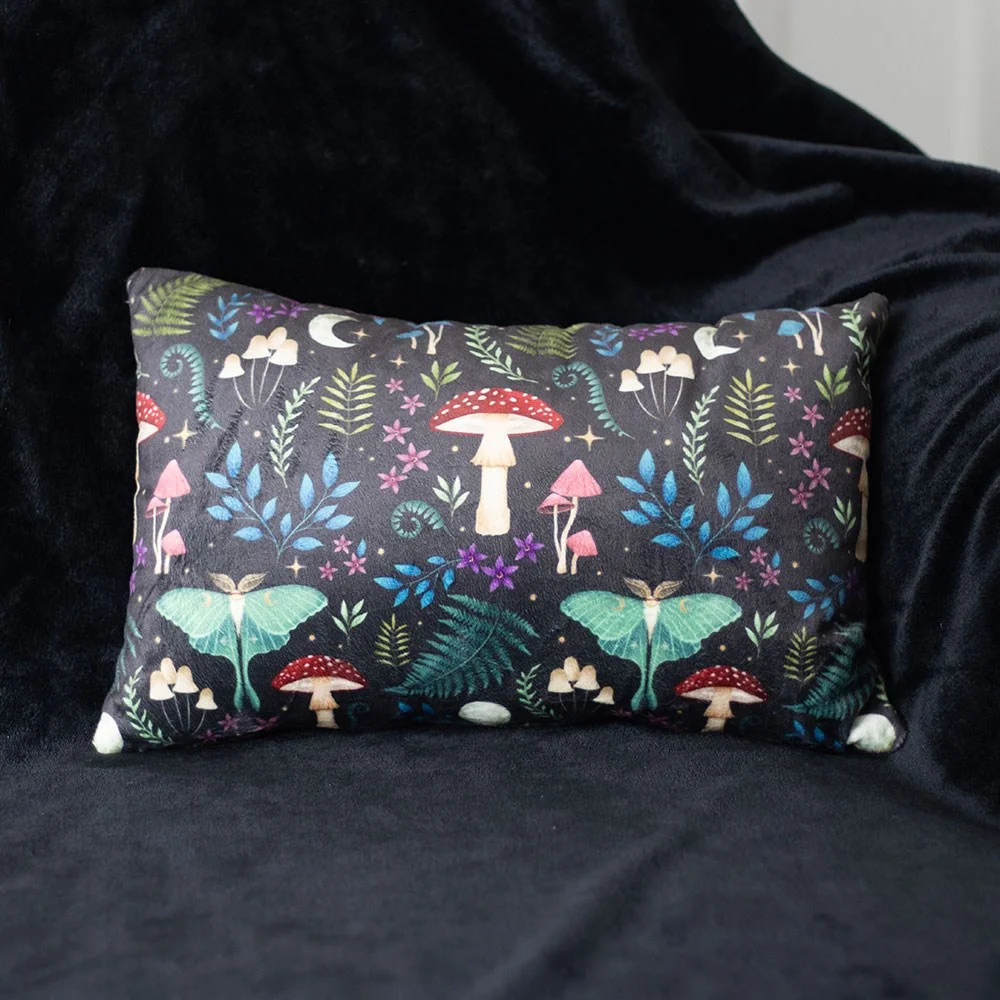 Rectangular dark forest cushion with mystical mushrooms and moonlit moths in rich colors on velvety fabric.