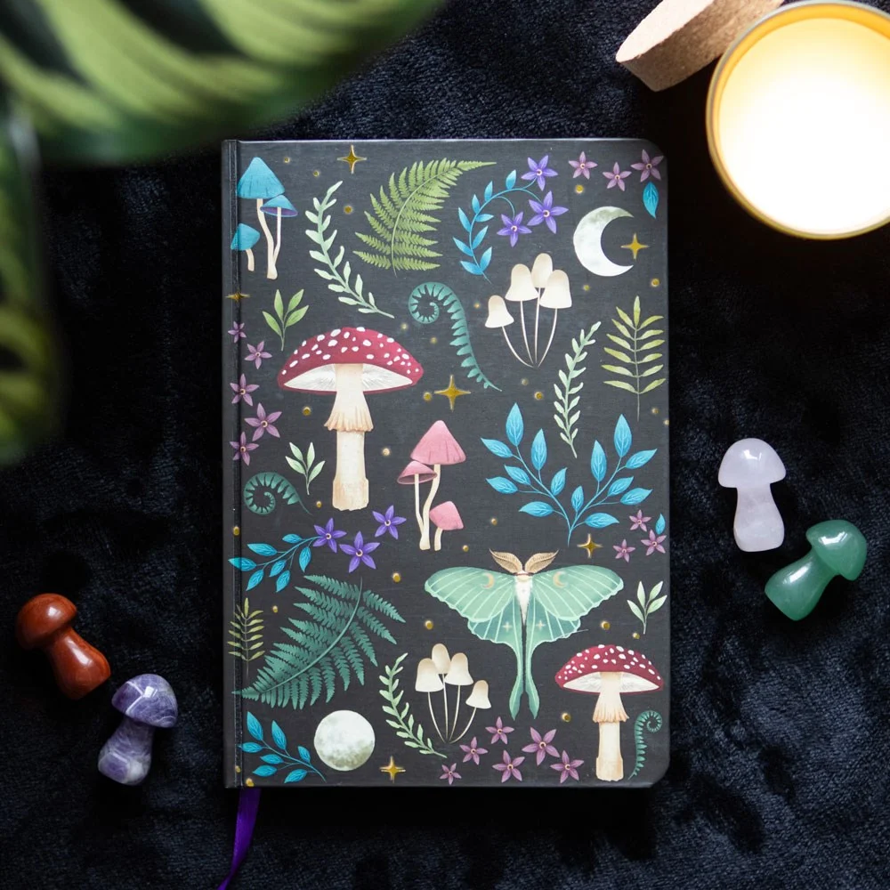 Dark forest notebook with ethereal design, mystical mushrooms, luna moth, gold foil edges, and ribbon marker on A5 size