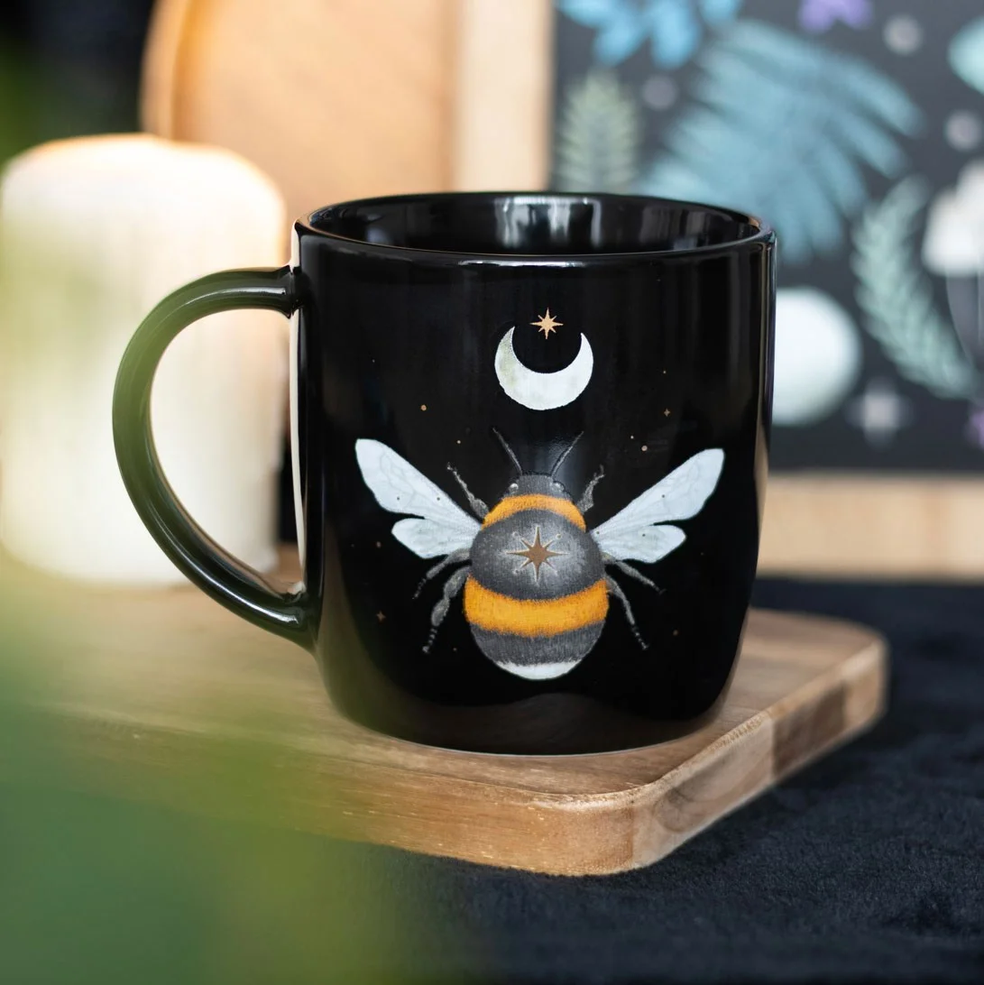 Black ceramic forest bee mug with intricate bee, crescent moon, and stars design, 340ml capacity, dishwasher safe