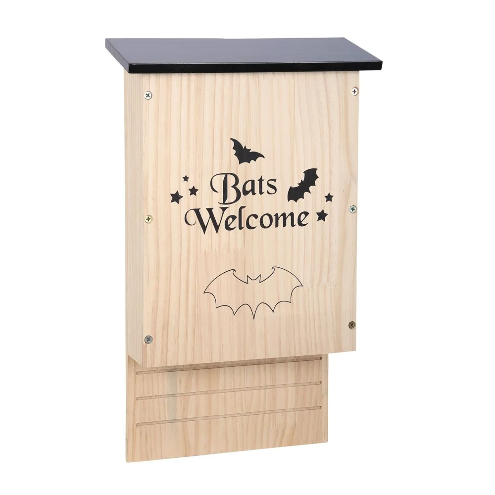 Wooden bat house mounted on a tree trunk in a sunny garden near hedges and trees for bat roosting and protection