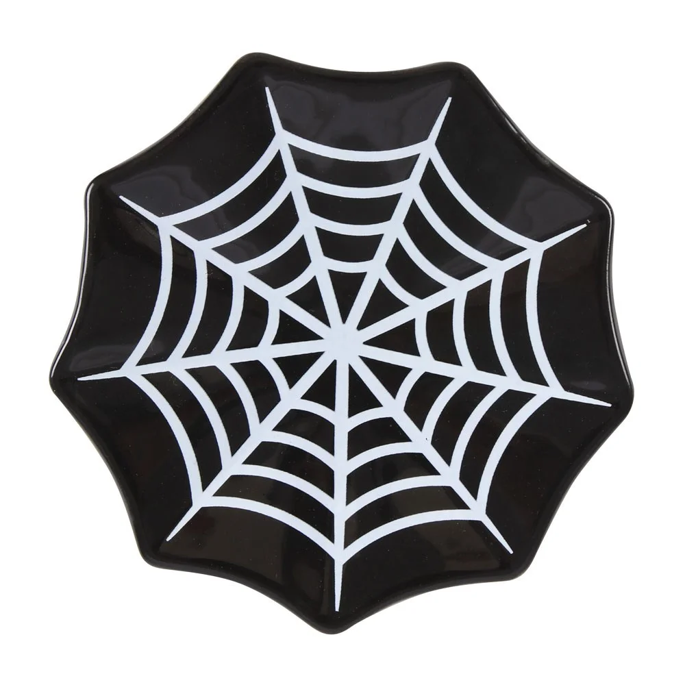 Black ceramic spiderweb trinket dish shaped like a spiderweb, holding small jewellery on a wooden surface