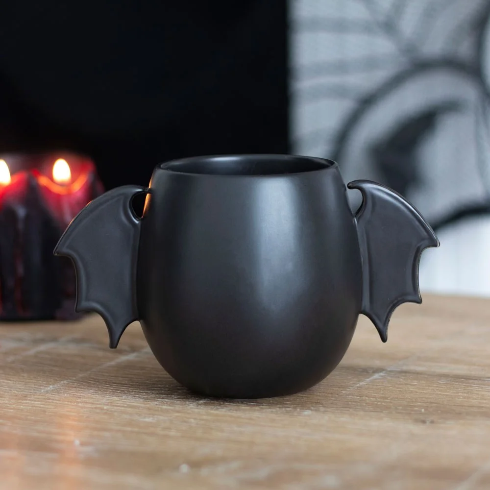 Black bat wing mug with wings as handles, 500ml capacity, sleek rounded design on white background