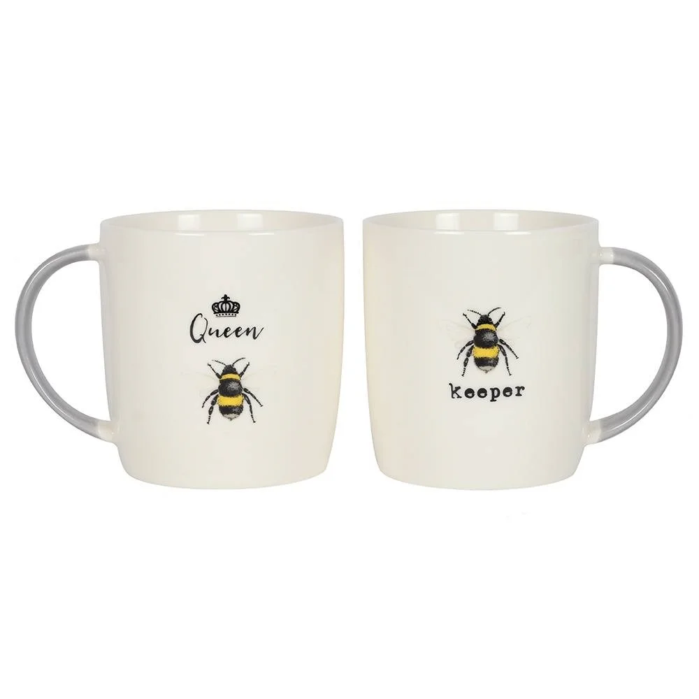 Pair of ceramic mugs with yellow and black bee designs, labeled Queen Bee and Bee Keeper, queen bee mug set