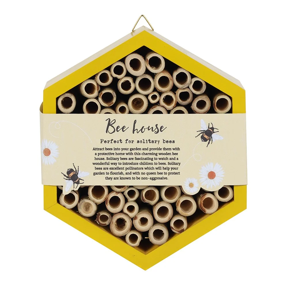 Compact wooden bee house with multiple hollow tubes for pollinators, designed for garden use, 17.5cm tall by 15cm wide