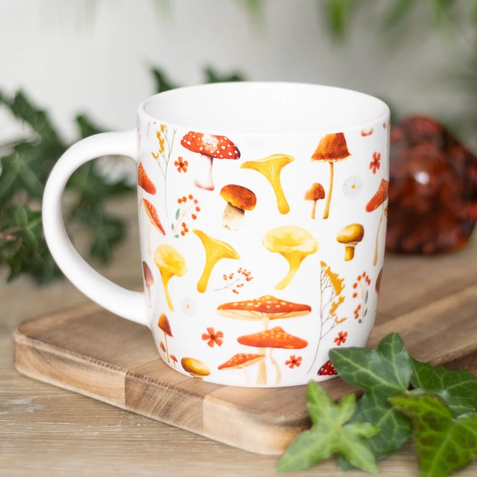 Cream mushroom print mug with red and white toadstools and floral accents, 360ml, microwave safe.