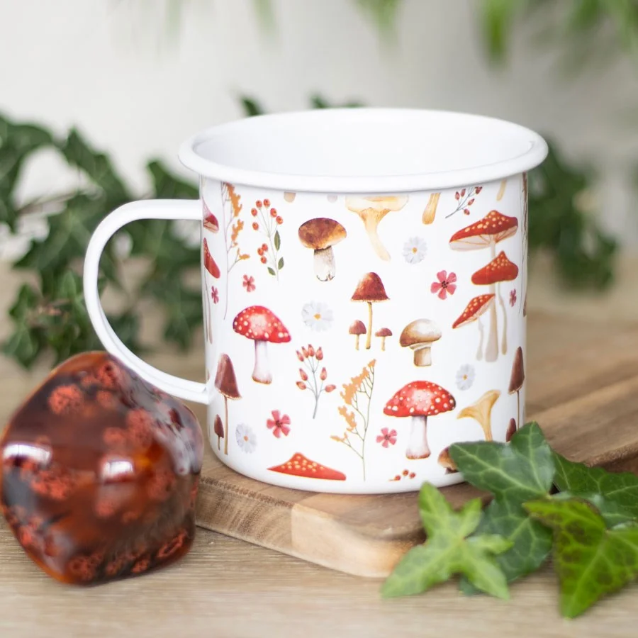 White enamel mushroom mug with red and white toadstool print, 500ml capacity, shown on a plain background