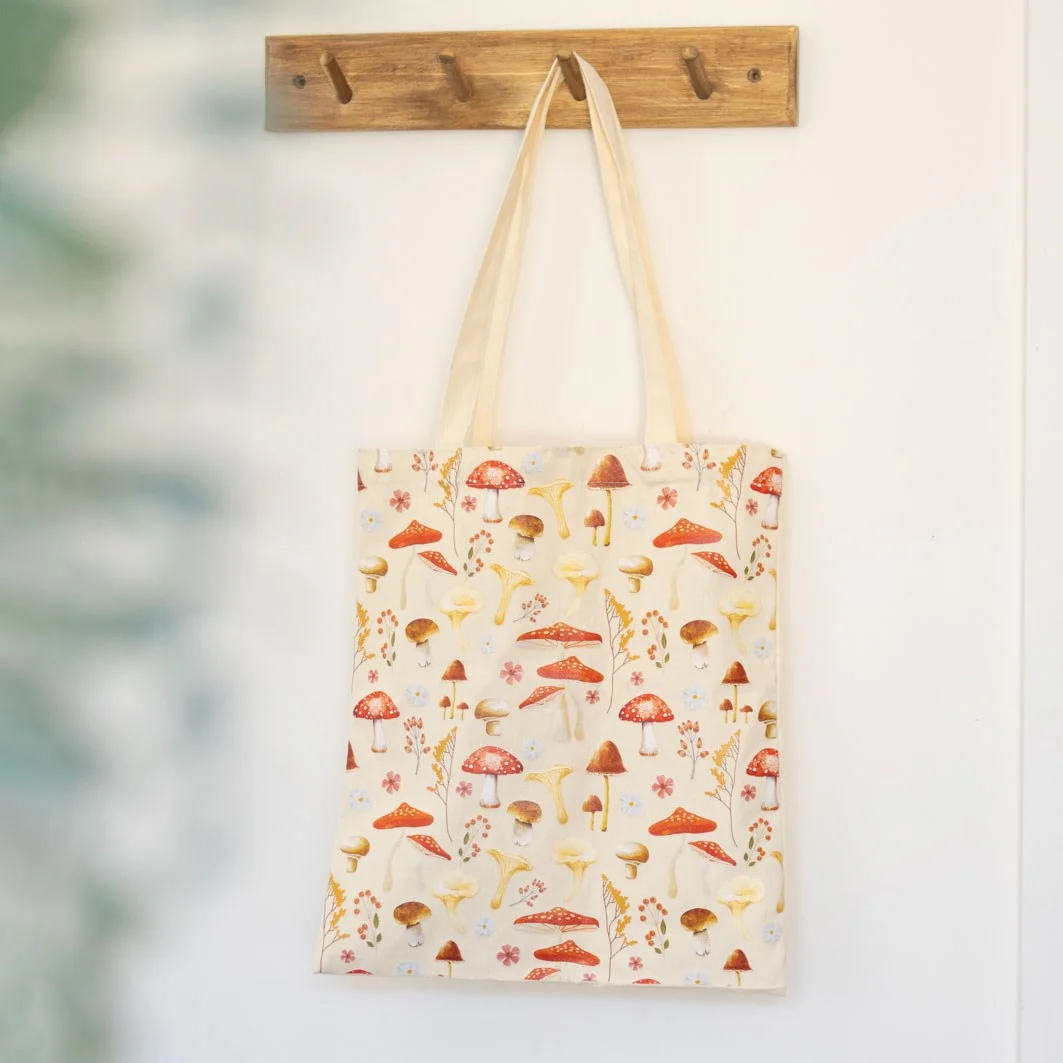 Canvas mushroom print tote bag with vibrant orange and red toadstool design, durable for groceries or books