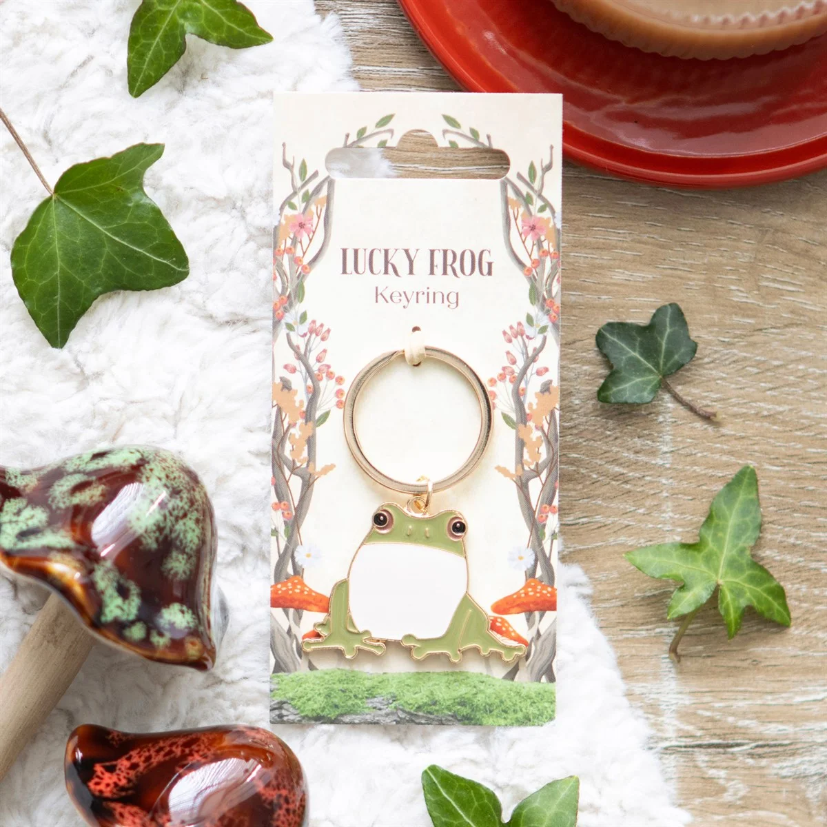 Lucky frog keyring with green frog charm on a forest-themed backing card for nature lovers and gift giving