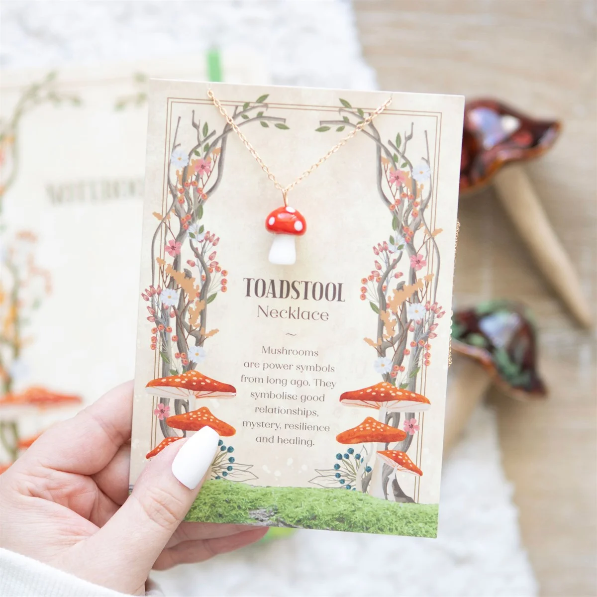 Toadstool charm necklace with glass mushroom pendant on 22cm nickel-free chain displayed on matching greeting card with envelope