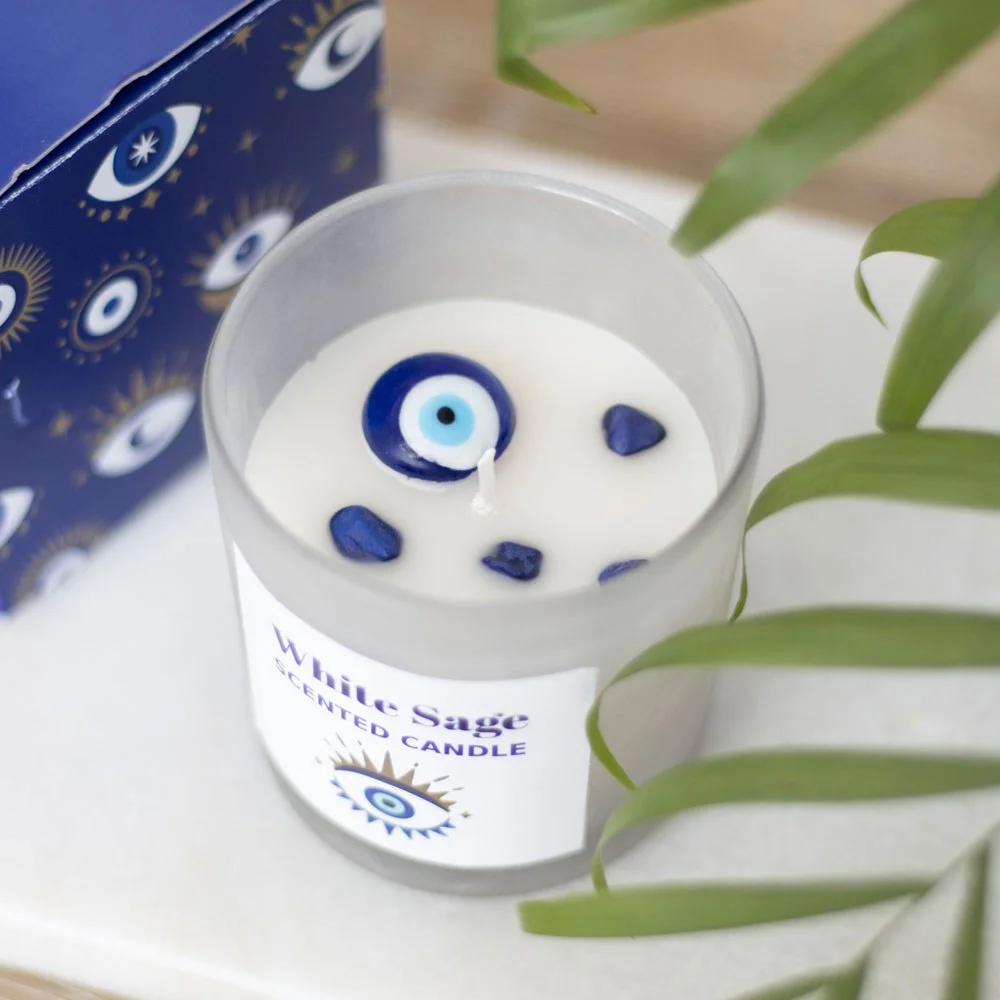 White Sage protection candle in frosted glass with sodalite crystal chips and All Seeing Eye charm on top