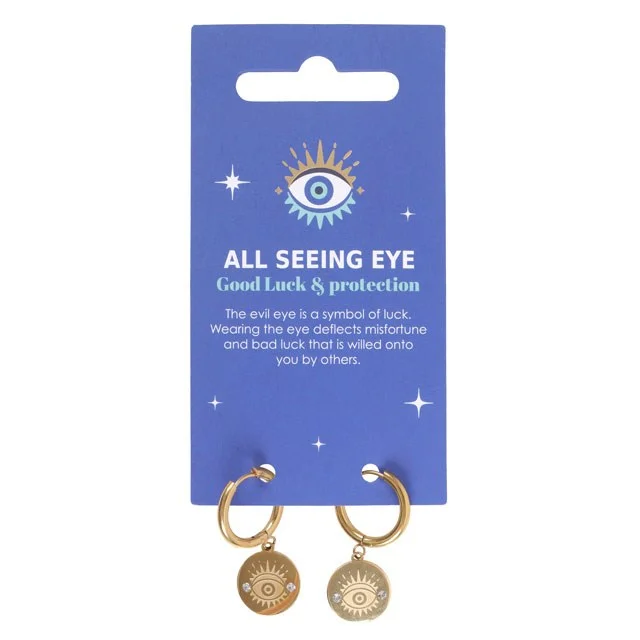 Pair of gold toned earrings featuring All Seeing Eye design on a blue card with charm meaning text