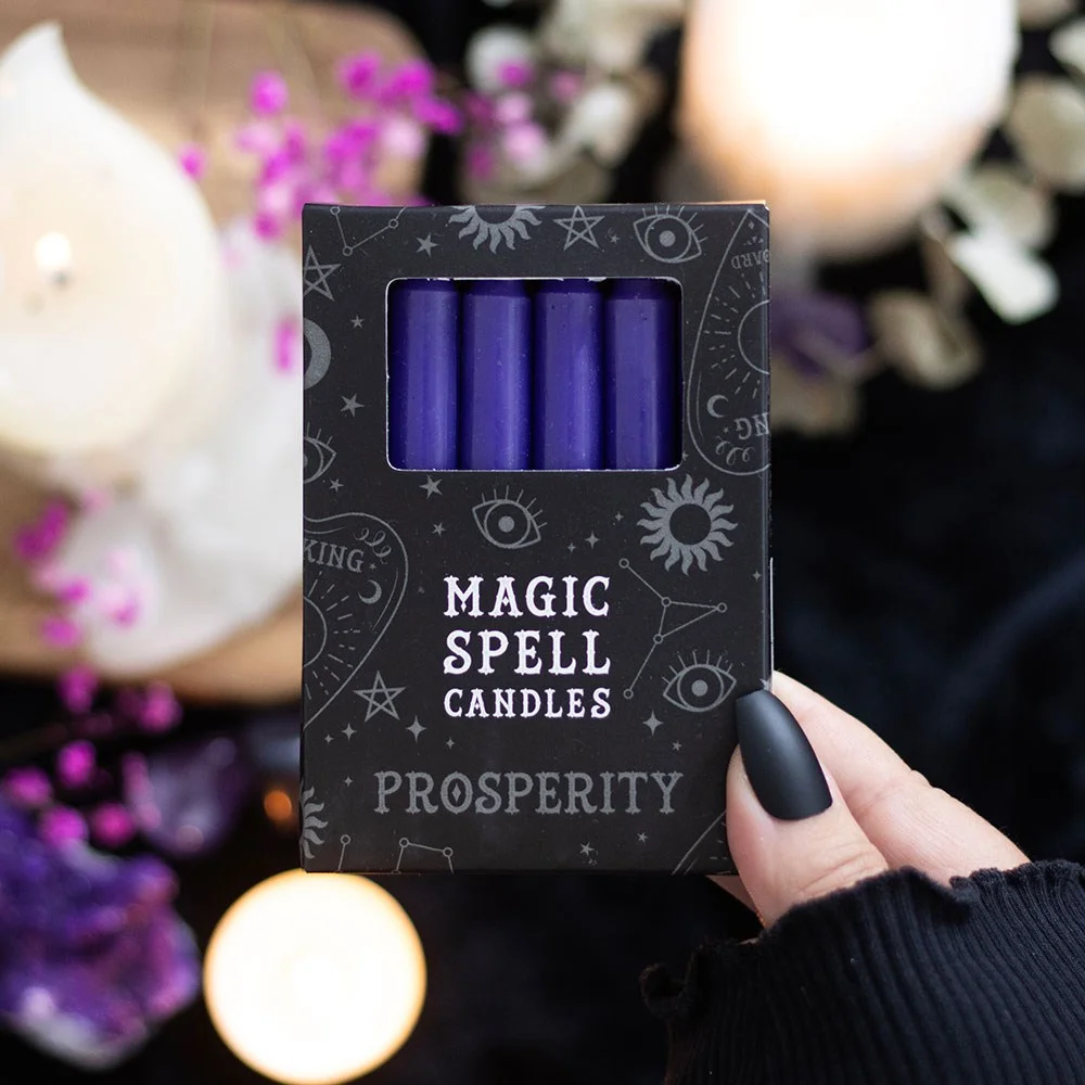 Set of 12 purple spell candles arranged in a row, labelled for prosperity rituals, vegan and unscented.