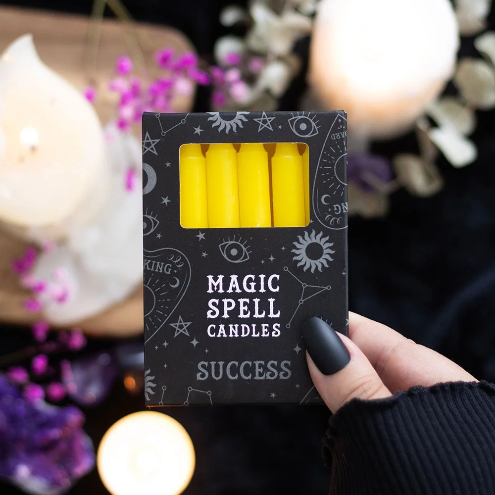 Set of 12 yellow spell candles arranged in rows, designed for success rituals, unscented and vegan-friendly.