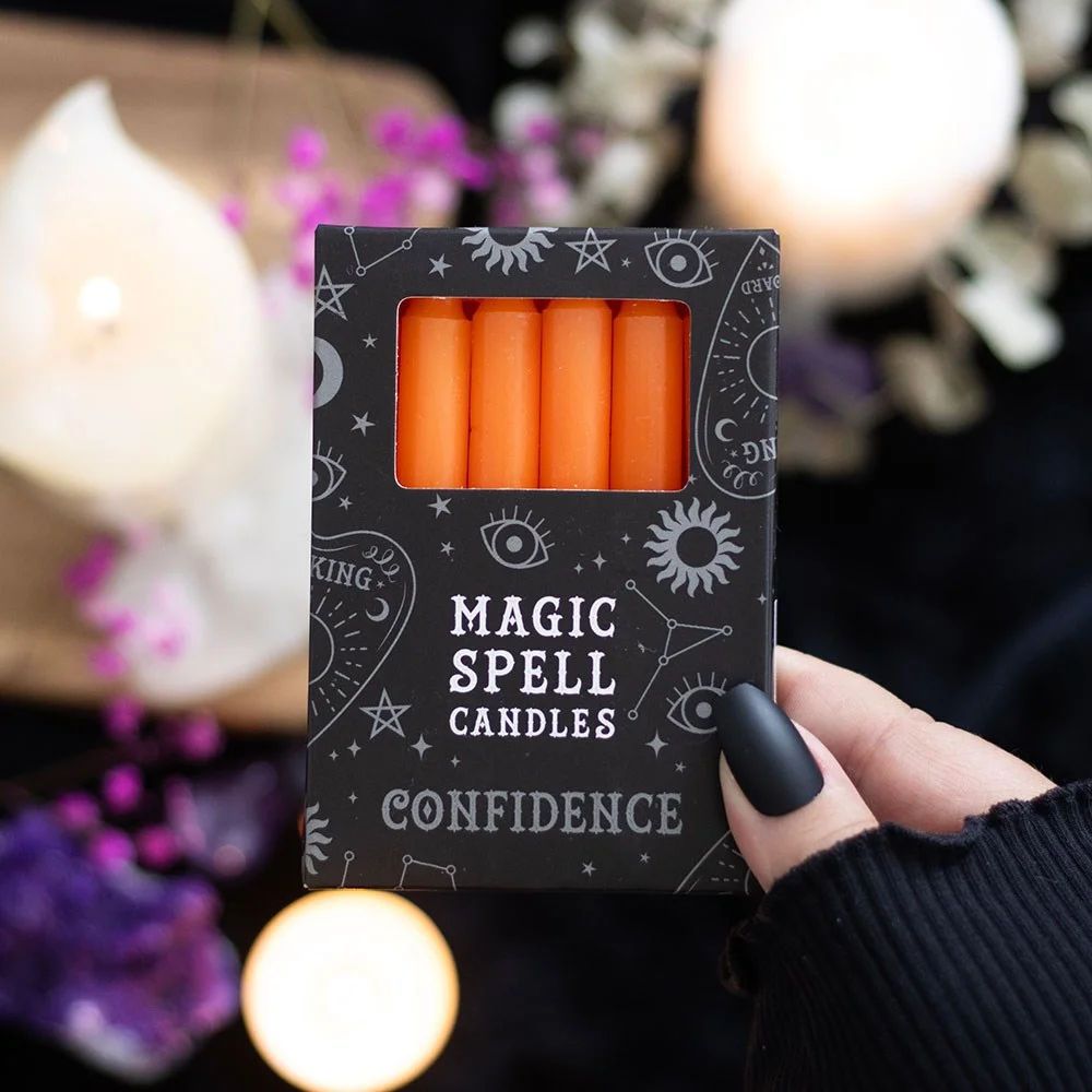 Set of 12 orange spell candles arranged in a row, designed for rituals to attract confidence and creativity